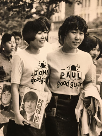Mieko Iwabuchi (right) walks with a friend wearing Beatles T-shirts in 1966. | COURTESY OF MIEKO IWABUCHI
