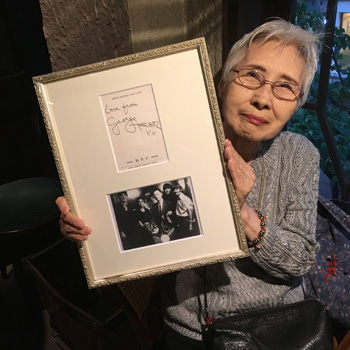 Beatles fan Kimi Aida displays George Harrison’s autograph in Tokyo on May 30. | STEVE McCLURE