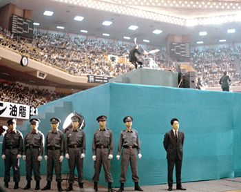Security surrounds the stage at Tokyo’s Budokan as the Beatles perform on June 30, 1966. | KYODO