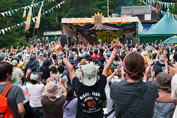 Fans hit the Atomic Cafe stage at a recent Fuji Rock Festival. The idea goes back to the 1980s. Fuji Rock founder Masahiro Hidaka used it as a launchpad to establish the main festival, and it remained a part of the event through the years. The stage took on new relevance following the nuclear meltdowns in Fukushima Prefecture. | COURTESY OF SMASH JAPAN
