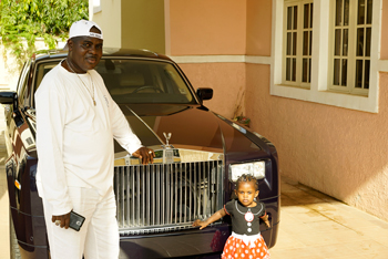 Darien, who returned to Nigeria when his former wife in Japan was pregnant, and has never met his bi-ethnic daughter, Naomi Sato, poses with his youngest daughter at his home in Abuja.